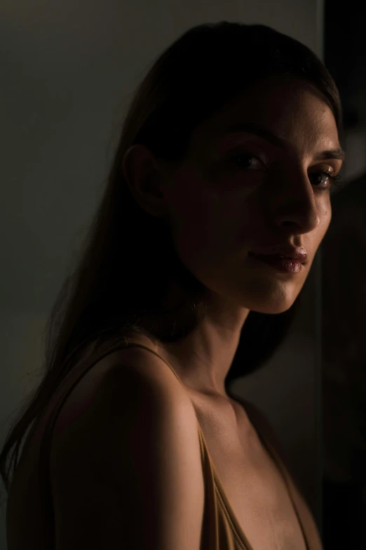 a woman standing in front of a window in a dark room, a character portrait, inspired by Elsa Bleda, pexels contest winner, hyperrealism, backlit beautiful face, angela sarafyan, medium format. soft light, dramatic light 8 k