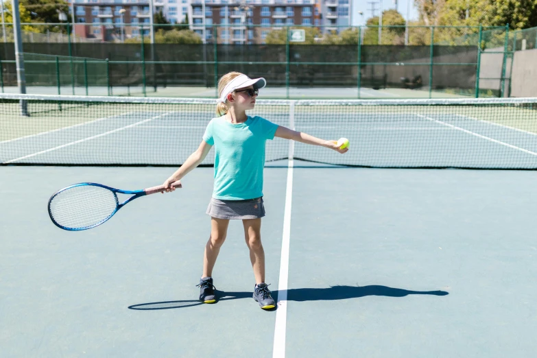 a little girl standing on top of a tennis court holding a racquet, a portrait, shutterstock, 15081959 21121991 01012000 4k, lachlan bailey, mid action swing, full body image