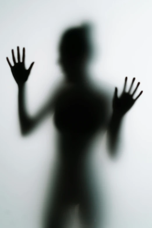 a silhouette of a person with their hands in the air, by Adam Chmielowski, conceptual art, transparent glass woman, focus on fearful model, silhouette :7, ghostly