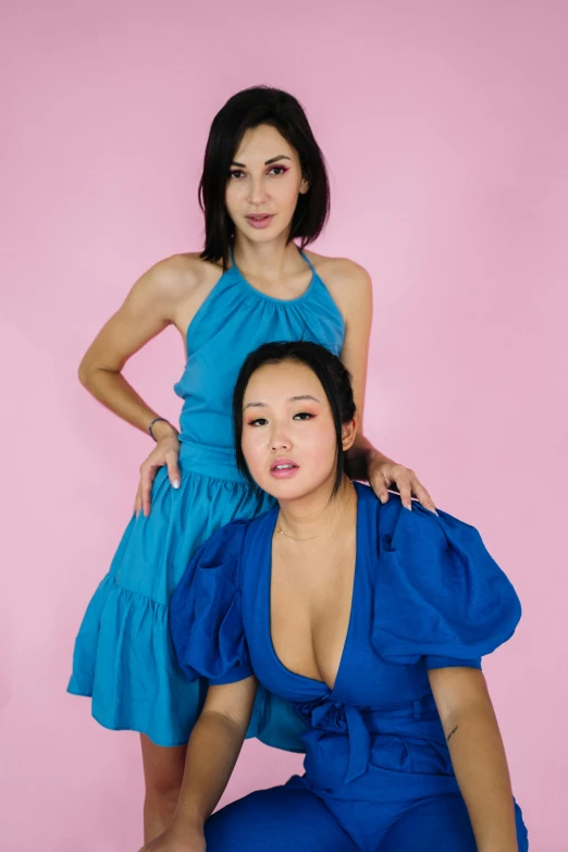 two women in blue dresses posing for a picture, an album cover, inspired by Wang Duo, reddit, 15081959 21121991 01012000 4k, half asian, non binary model, big bust