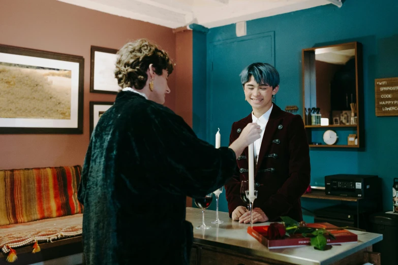 a couple of people that are standing in a room, an album cover, unsplash, private press, beautiful androgynous prince, holding a candle, kpop, gentlemens dinner