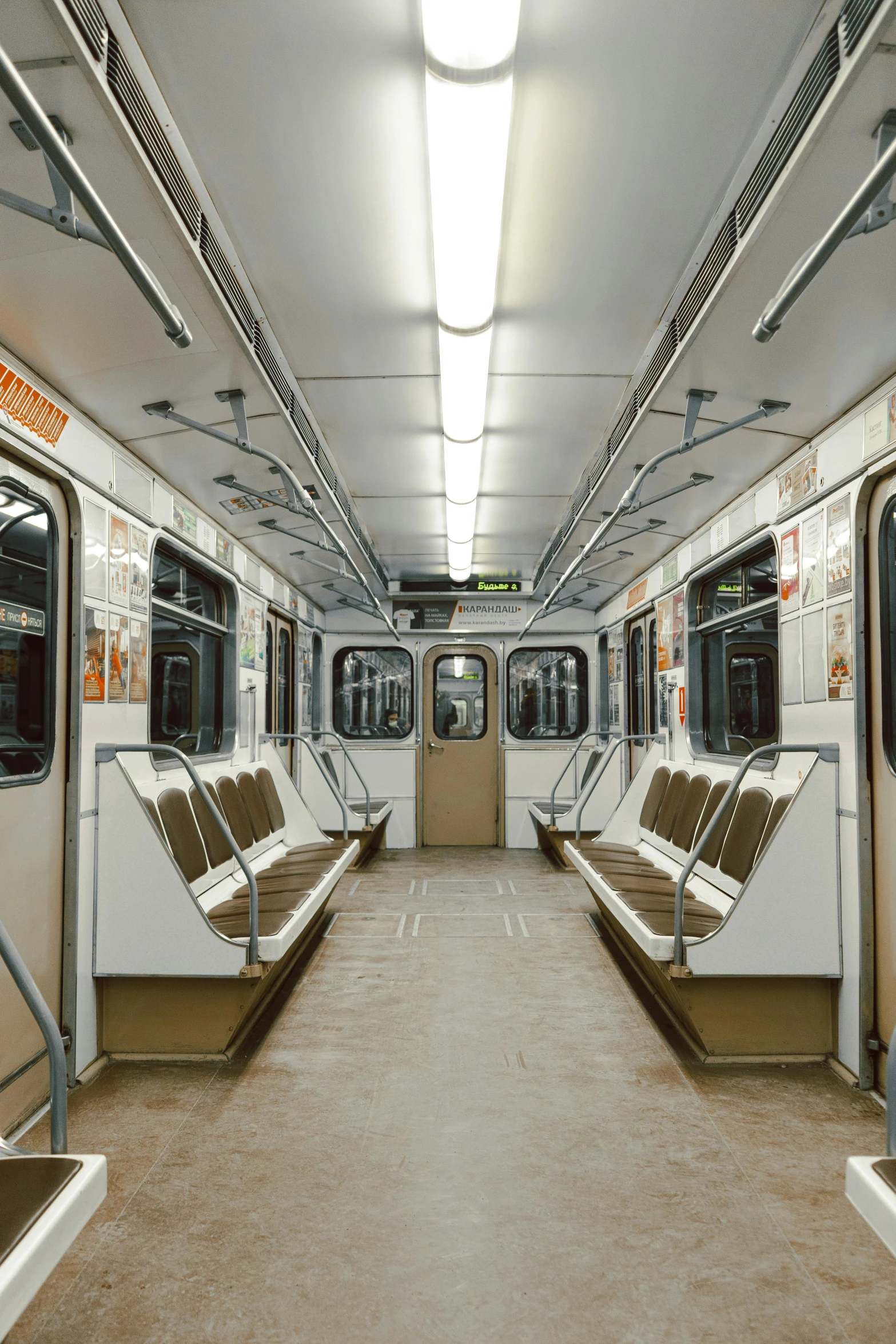 a subway car filled with lots of empty seats, by karlkka, brown and white color scheme, minneapolis, panorama view, square