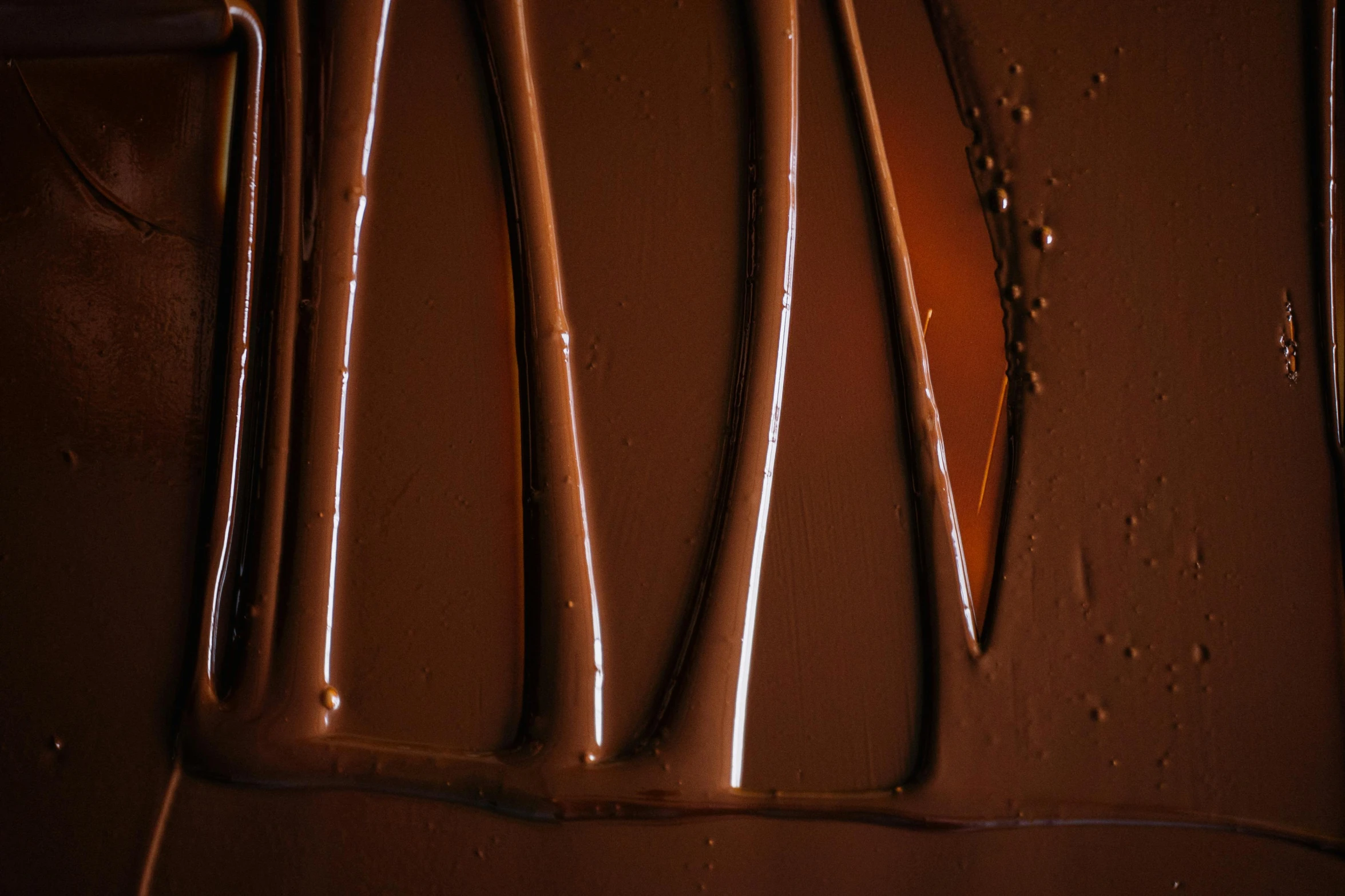 a group of utensils sitting on top of a counter, inspired by Pierre Soulages, trending on pexels, abstract expressionism, chocolate river, close up shot from the side, caramel, shot on hasselblad