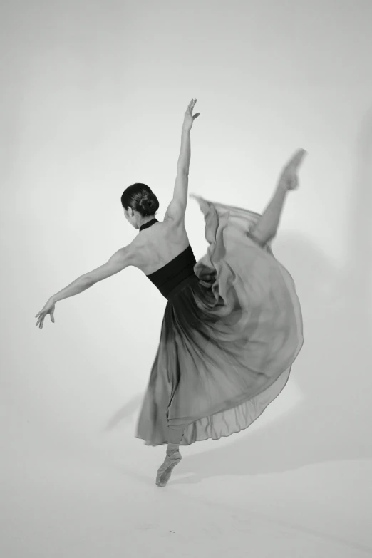 a black and white photo of a woman in a dress, arabesque, alison williams, steve huston, taken in the late 2000s, dynamic!!