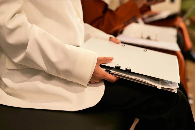 a close up of a person holding a laptop, private press, white robes, official documentation, formal attire, amanda clarke