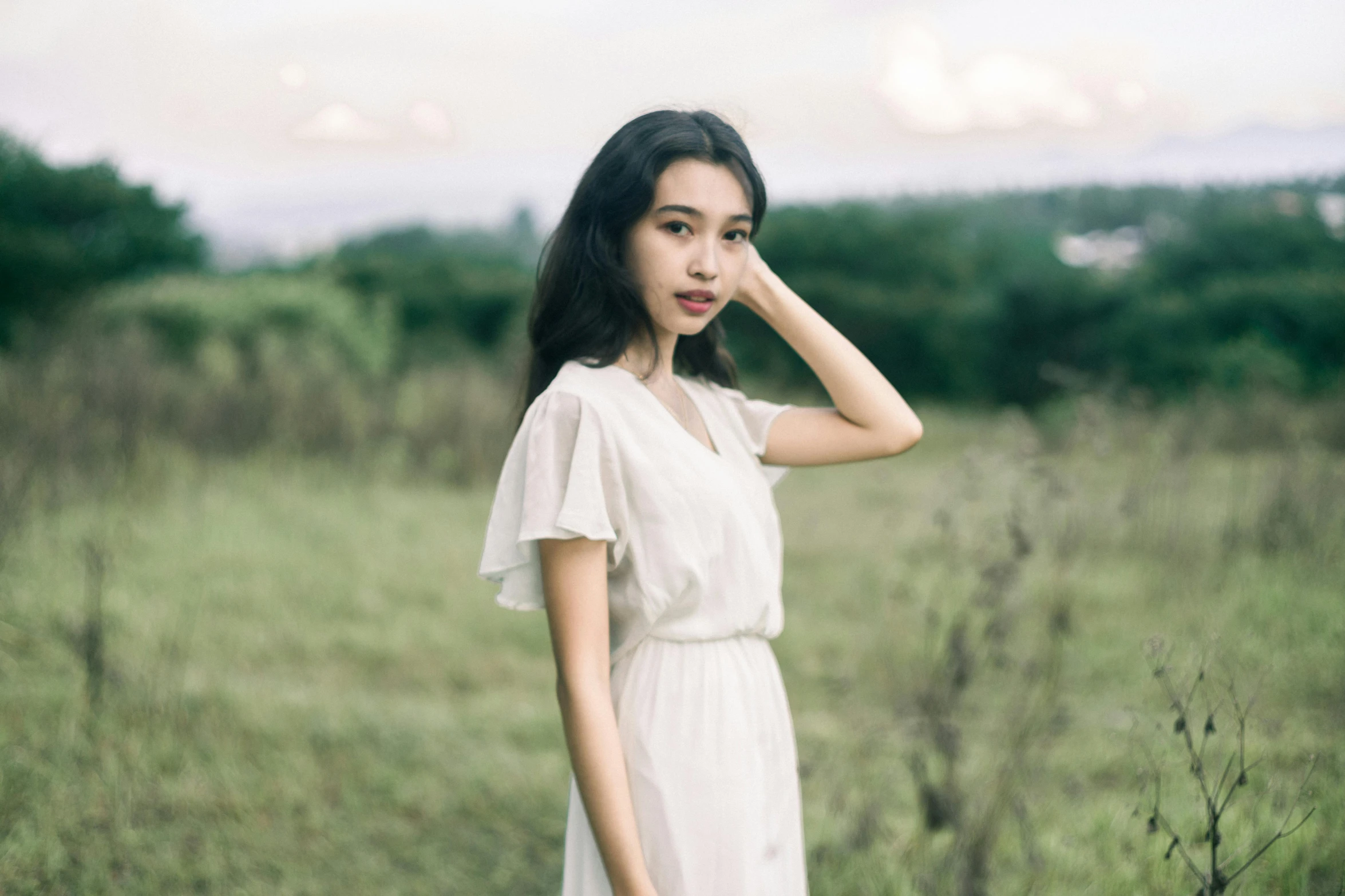 a woman in a white dress standing in a field, inspired by Tang Yifen, pexels contest winner, kiko mizuhara, thin aged 2 5, anime thai girl, medium format