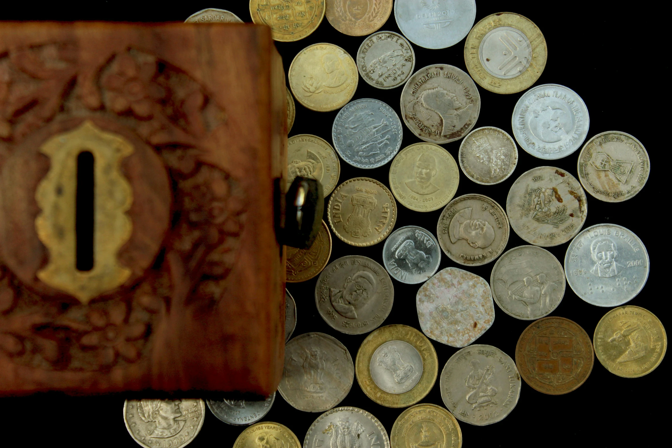 a wooden box sitting on top of a pile of coins, by Alejandro Obregón, pexels contest winner, assemblage, hindu, panorama, silver, thumbnail