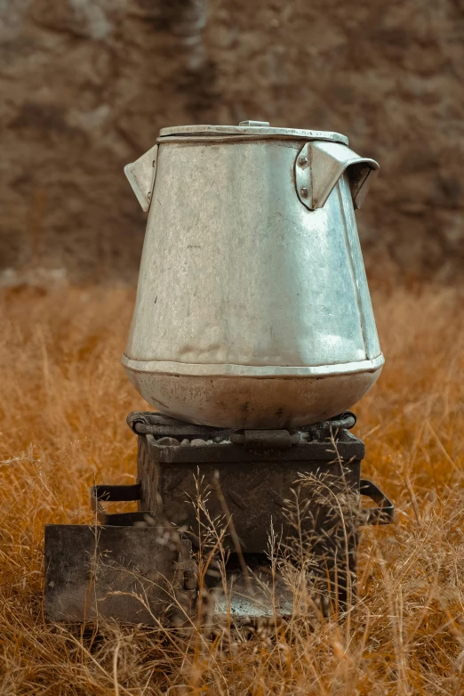 a kettle sitting on top of a stove in a field, tall, substance designer metal, nomad, dessert