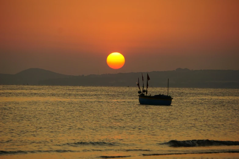 a boat floating on top of a body of water, by Robert Sivell, pexels contest winner, romanticism, beach sunset background, marbella, unedited, asian sun