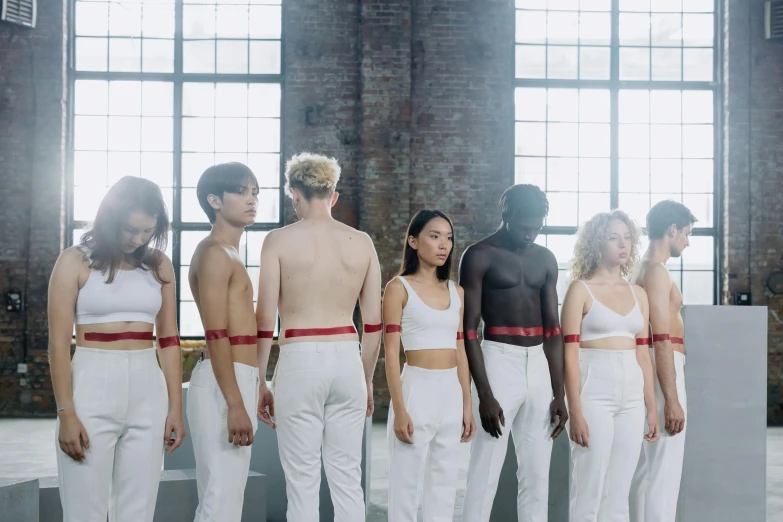 a group of people standing next to each other, inspired by Vanessa Beecroft, pexels contest winner, antipodeans, white belt, thin red lines, bare midriff, various colors