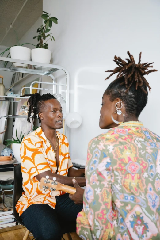 two people sitting next to each other in a room, trending on unsplash, black arts movement, short dreadlocks with beads, customers, in a kitchen, giving an interview