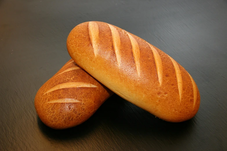 two loaves sitting next to each other on a table, high quality product image”, very crisp details, thumbnail, frontal shot