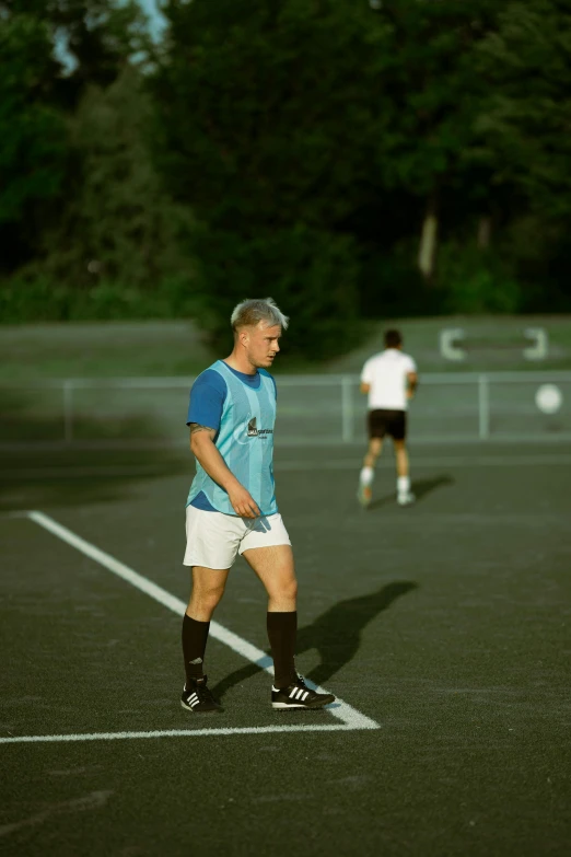 a group of young men playing a game of soccer, an album cover, reddit, happening, short blue haired woman, alessio albi, 30 year old man :: athletic, on a soccer field