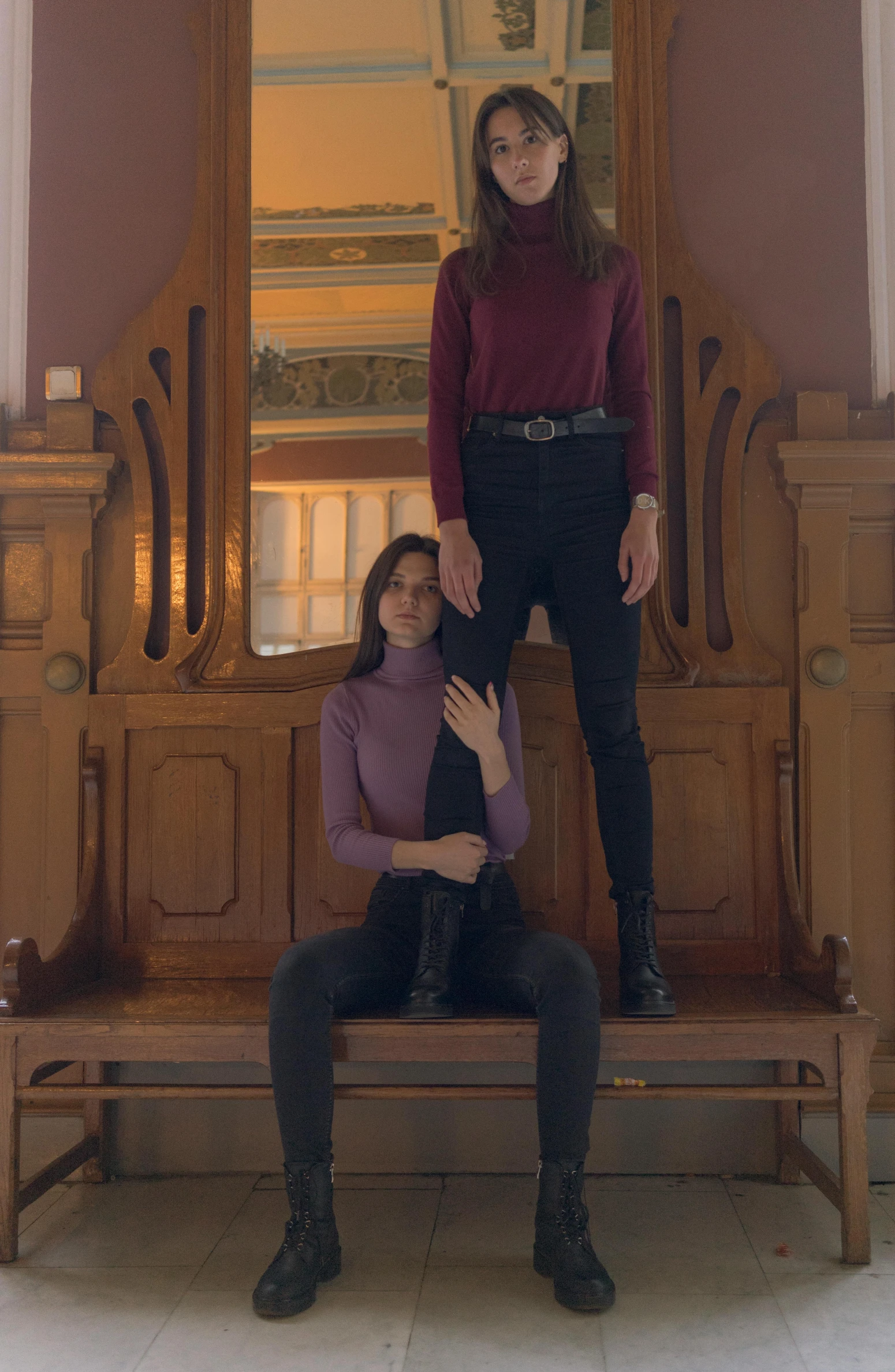 two women sitting on a bench in front of a mirror, an album cover, inspired by Vanessa Beecroft, pexels contest winner, renaissance, sitting on a grand staircase, standing on two legs, ( ( theatrical ) ), american gothic interior