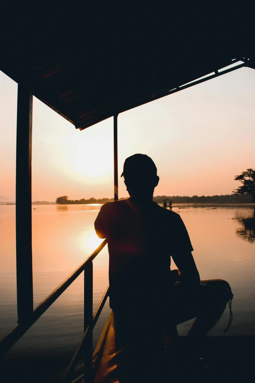 a man sitting on a boat watching the sunset, happening, in an african river, yoga, honored, uploaded