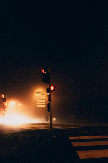 a couple of traffic lights sitting on the side of a road, by Adam Marczyński, dust mist, kansas town at midnight, police sirens in smoke, taken on a 2000s camera