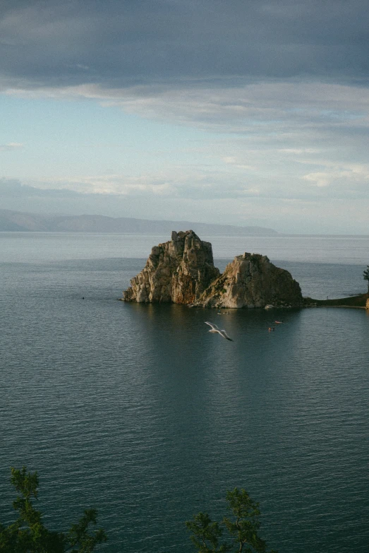 a body of water that has some rocks in it, flying cloud castle, near lake baikal, vallejo, islands!!!!!