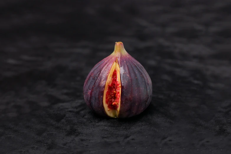 a close up of a fig on a black surface, a picture, trending on pexels, purple and red, miniature product photo, from the front, female gigachad