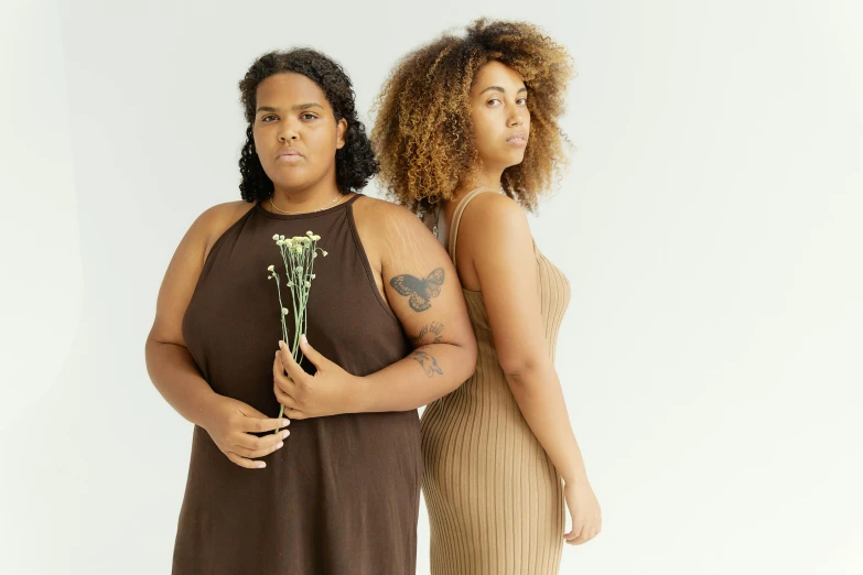 a couple of women standing next to each other, trending on pexels, renaissance, brown body, overweight, botanicals, black and brown