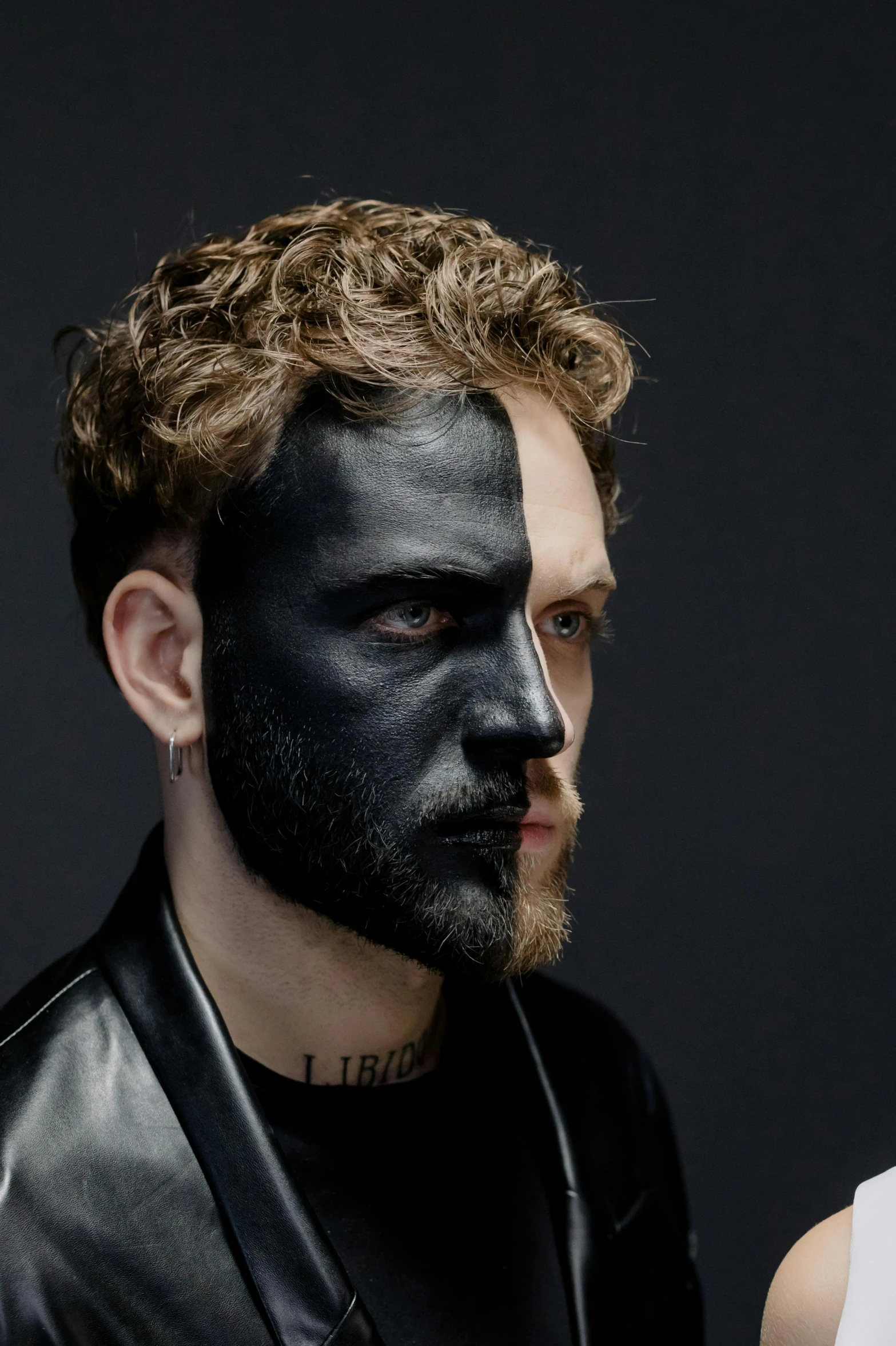 a man and a woman with black paint on their faces, an album cover, inspired by Hendrick van Balen, trending on pexels, mannerism, post malone, half cat, extremely handsome, wrapped in black