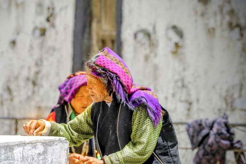 a couple of women standing next to each other, inspired by Steve McCurry, pexels contest winner, cloisonnism, filling with water, sichuan, people at work, profile image