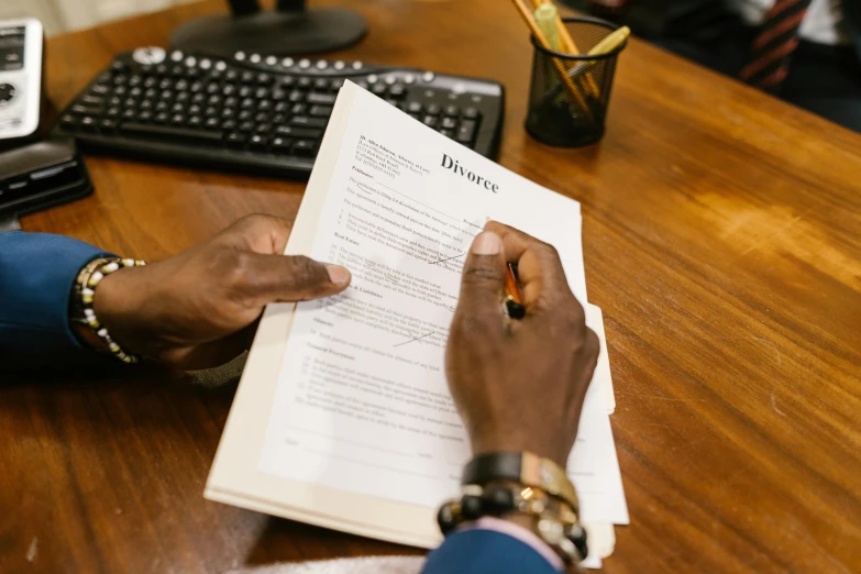 a person sitting at a desk reading a book, celebrating an illegal marriage, signing a bill, jemal shabazz, 15081959 21121991 01012000 4k