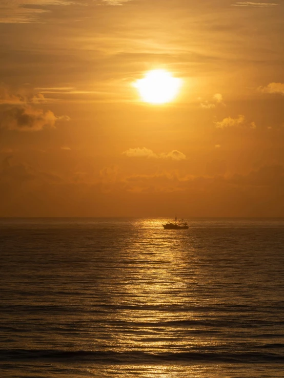 a large body of water with a boat in the distance, by Jan Tengnagel, pexels contest winner, romanticism, hexagon in front of the sun, bali, today\'s featured photograph 4k, golden glistening