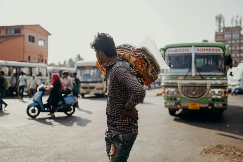 a man standing in the middle of a busy street, by Carey Morris, pexels contest winner, india, with a bunch of stuff, public bus, his back is turned