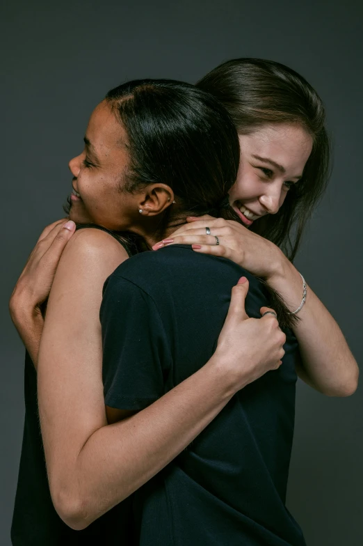a couple of women standing next to each other, pexels contest winner, antipodeans, hugging each other, jordan grimmer and natasha tan, promotional image, studio photo