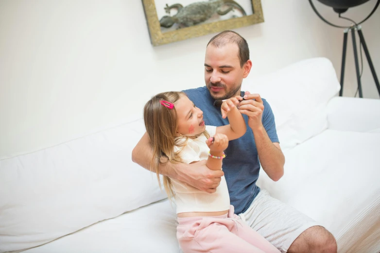 a man and a little girl sitting on a couch, pexels contest winner, figuration libre, holding maracas, holding paws, profile image, as an action figure