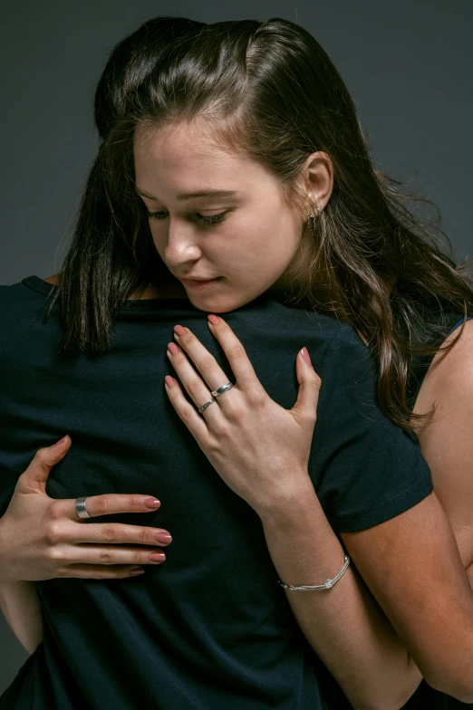 a couple of people that are hugging each other, crying and reaching with her arm, promo image, young woman in her 20s, rings