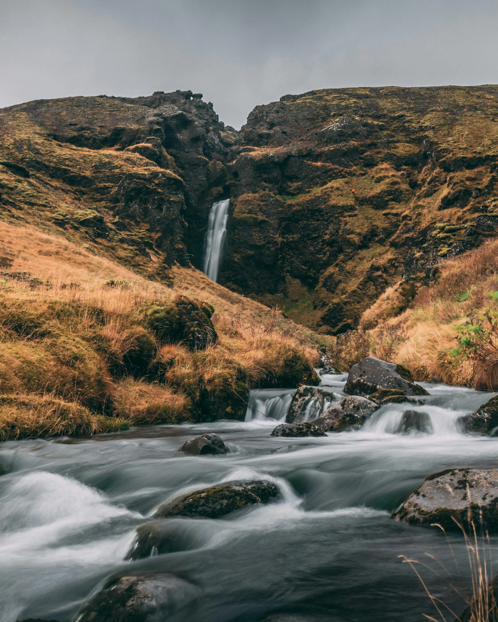 a waterfall flowing down the side of a mountain, by Johannes Voss, pexels contest winner, hurufiyya, next to a small river, thumbnail, sarenrae, high quality photo