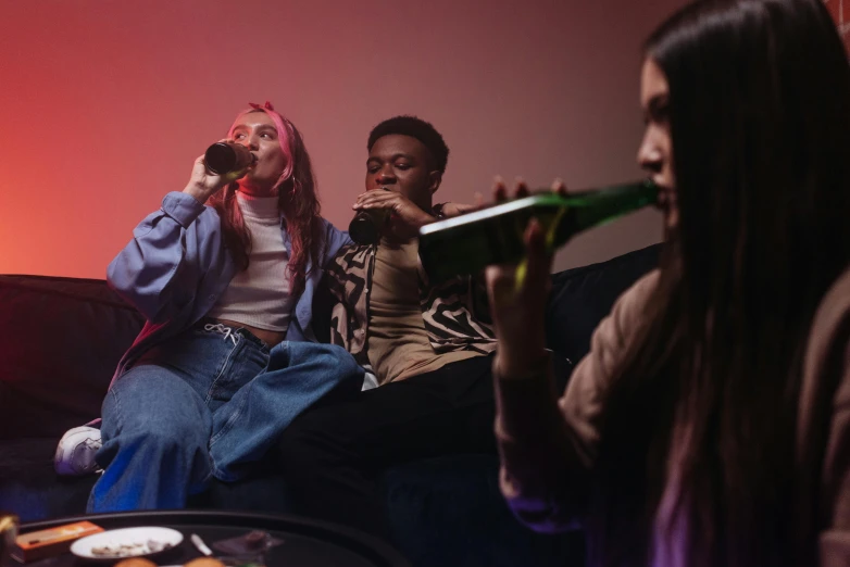 a couple of people that are sitting on a couch, inspired by Nan Goldin, trending on pexels, happening, girl drinks monster energy, group of people, bong, college party