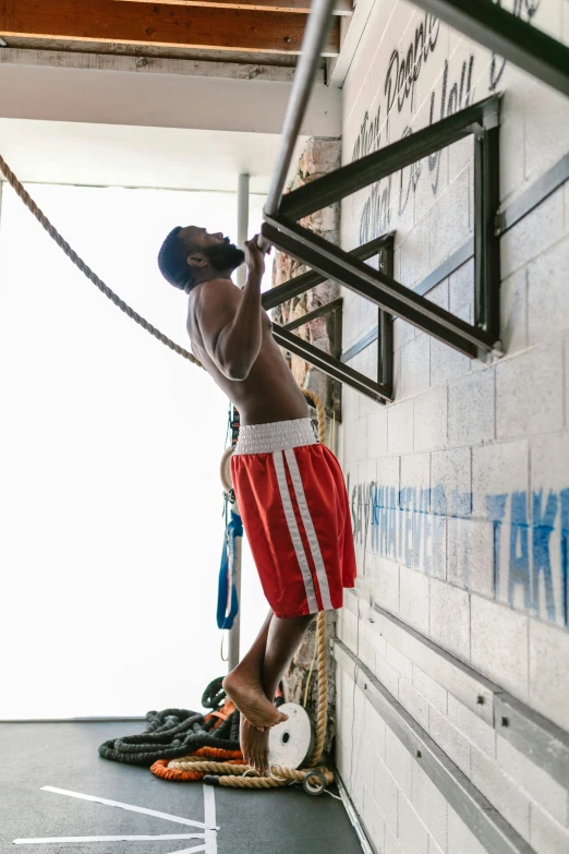 a man hanging from a rope in a gym, square, espn, rodney matthew, impactful