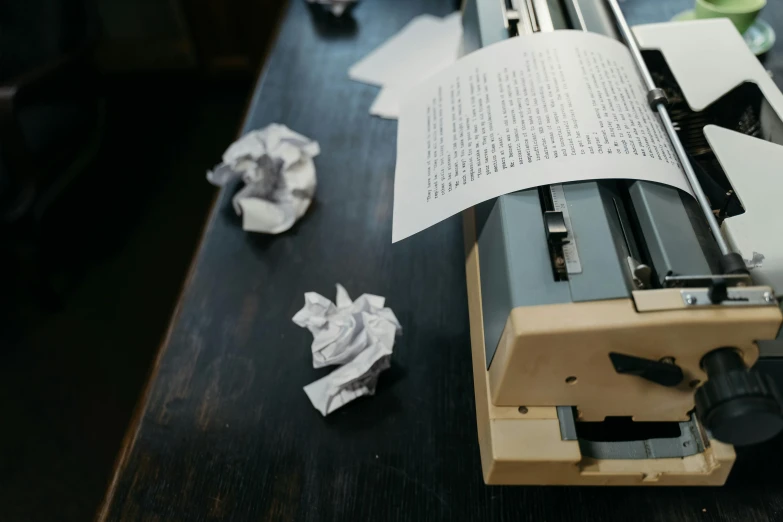 a typewriter sitting on top of a wooden table, a photocopy, by Everett Warner, pexels contest winner, private press, torn paper, paper origami, the book is closed, as well as scratches