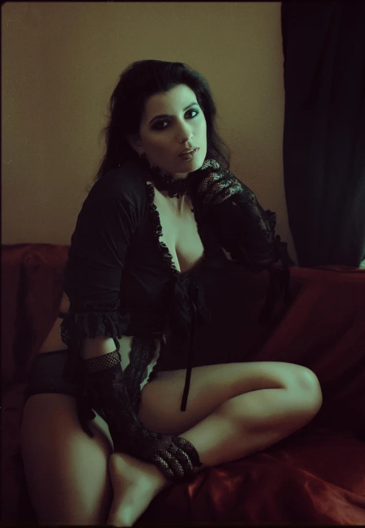 a woman sitting on top of a red couch, inspired by Elsa Bleda, reddit, renaissance, burlesque psychobilly, portrait of a dark witch, sepia photography, with haunted eyes and dark hair