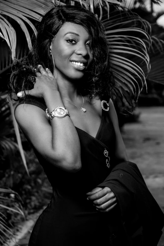 a black and white photo of a woman in a dress, a black and white photo, inspired by Chinwe Chukwuogo-Roy, smiling seductively, with palm trees in the back, pr shoot, dark skin