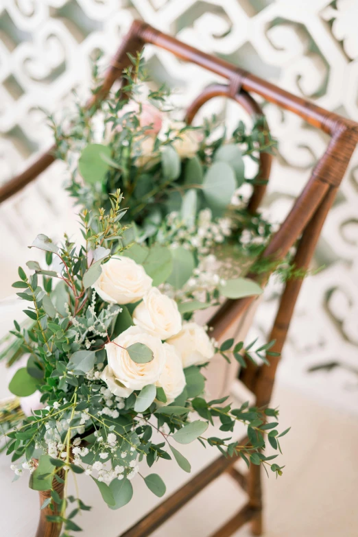 a chair with a bunch of flowers on it, floral details, eucalyptus, upclose, two