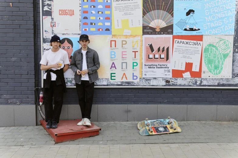 a couple of men standing next to each other on a sidewalk, a poster, by Alexander Litovchenko, unsplash, street art, plays skateboards, russian academicism, storefront, vitaly bulgarov and mike nash