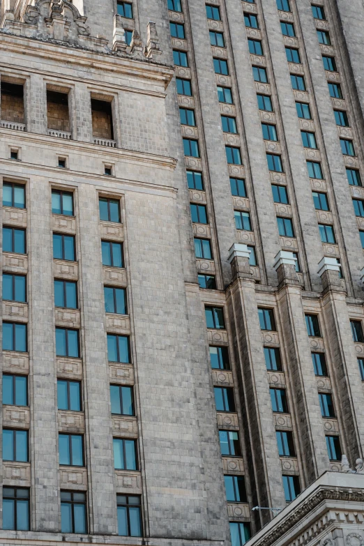 a tall building with a clock on top of it, unsplash, socialist realism, tetris, low quality photo, russia, stone facade