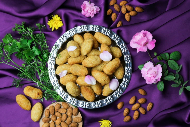 a bowl filled with nuts on top of a purple cloth, hurufiyya, flowers in background, background image, covered with pink marzipan, thumbnail