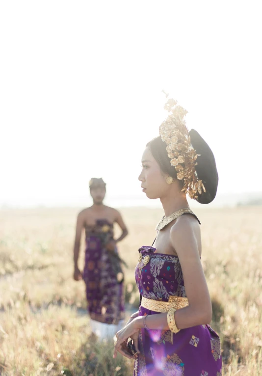 a couple of women standing next to each other in a field, inspired by Sasha Putrya, happening, intricate headpiece, bali, square, **cinematic