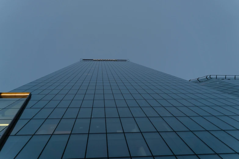 a very tall building with a lot of windows, inspired by Richard Wilson, unsplash, minimalism, low quality photo, low ultrawide shot, eyelevel perspective image, screens