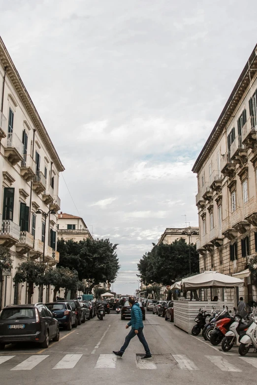 a man riding a skateboard down a street next to tall buildings, a picture, by Alessandro Allori, renaissance, white marble buildings, summer street near a beach, on a great neoclassical square, as photograph