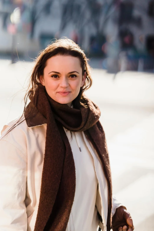 a woman walking down a street holding a pair of skis, a portrait, inspired by Louisa Matthíasdóttir, pexels contest winner, renaissance, dafne keen, headshot profile picture, square, wearing a duster coat