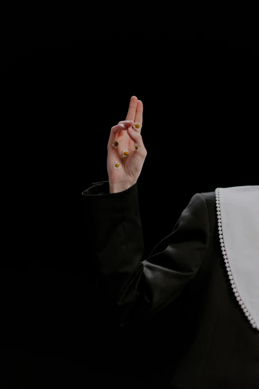 a nun giving a peace sign in front of a black background, by Marina Abramović, unsplash, renaissance, dressed as a judge's robes, realistic hand, film still of barack obama, 15081959 21121991 01012000 4k