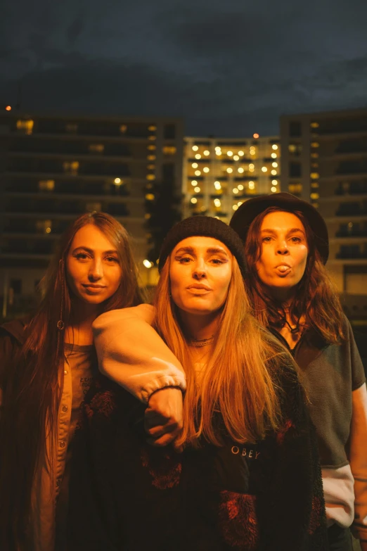 a group of young people standing next to each other, an album cover, inspired by Nan Goldin, unsplash, antipodeans, three women, stoner rock concert, standing on a rooftop, headshot