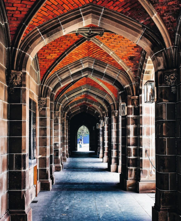 an image of a hallway in a building, inspired by Sydney Prior Hall, unsplash contest winner, academic art, flying buttresses, red bricks, tudor architecture, stone pathways