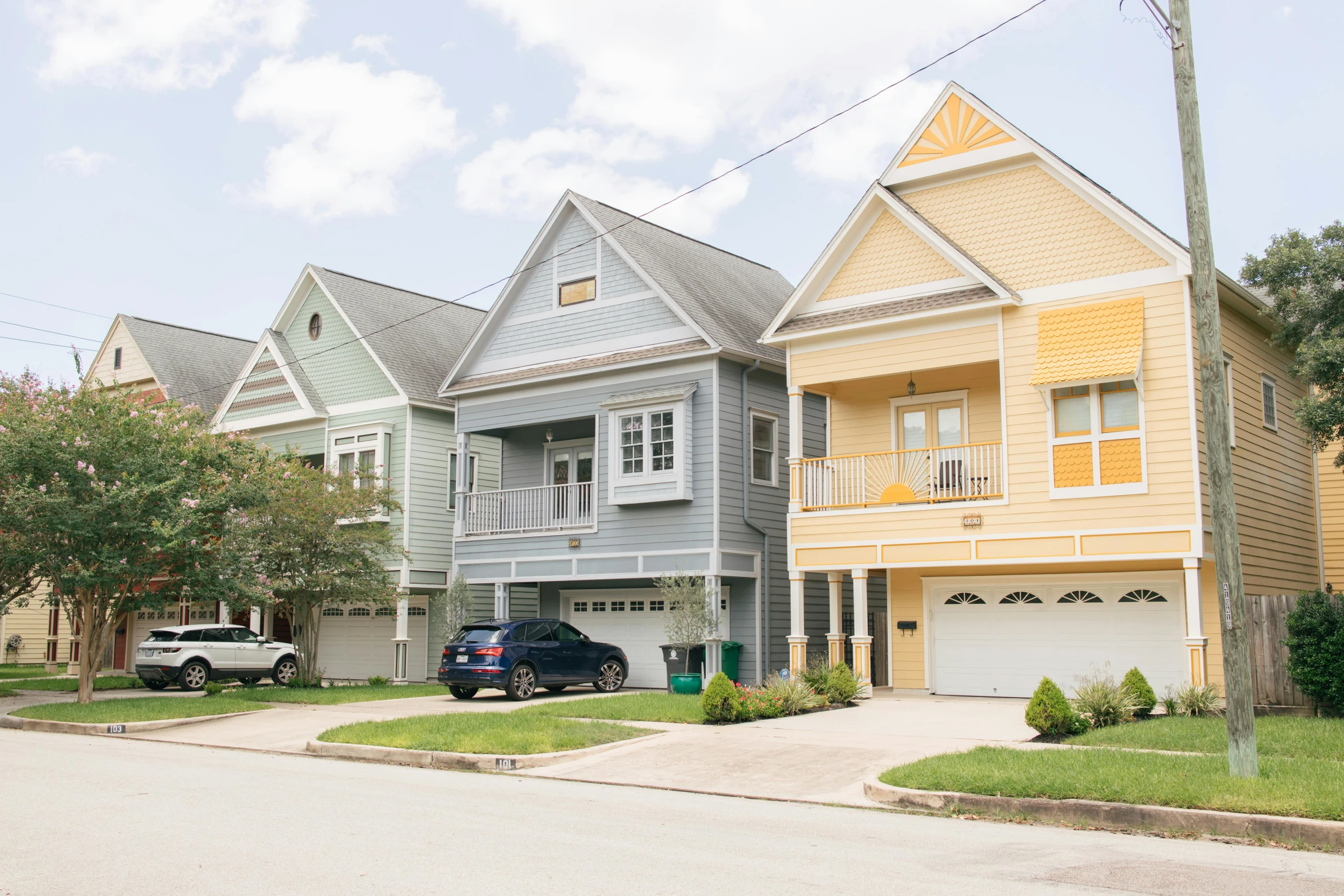 a row of houses on a residential street, by Carey Morris, fan favorite, high res photograph, multicolored, suburban