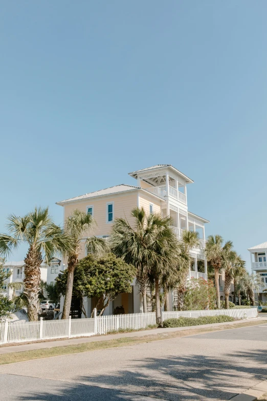 a couple of houses sitting on the side of a road, by Lynn Pauley, unsplash, visual art, the emerald coast, front elevation view, multiple stories, overexposed photograph